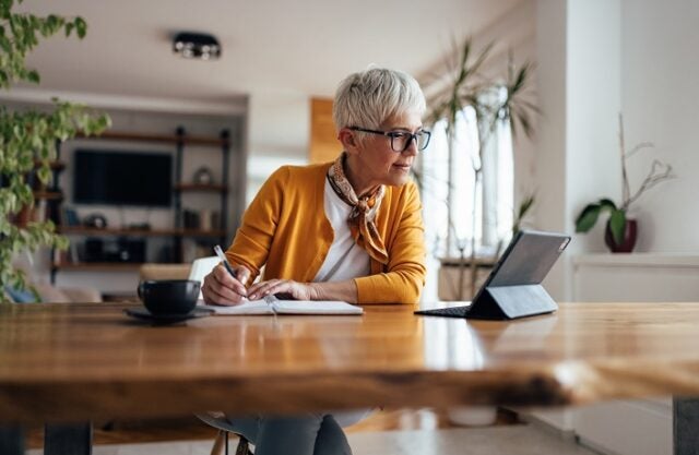 Senior businesswoman, working hard, from home office.